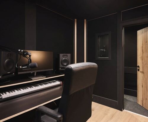 Recording studio with keyboard, microphones and vocal booth