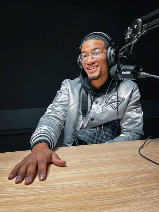 Smiling podcaster with headphones and microphone, ready to record a podcast in antwerp