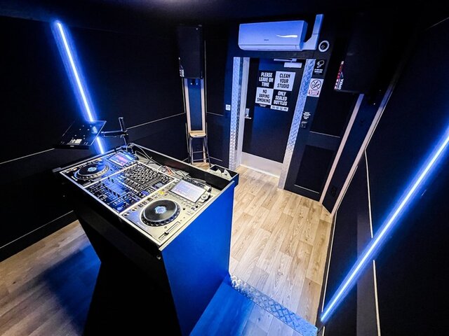 Wide view of a DJ studio with CDJ-3000, DJM-A9 and blue LED lighting