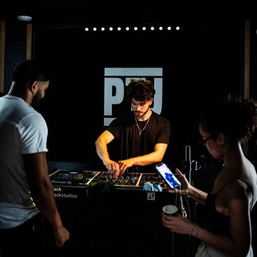 DJ mixing for two friends in a DJ studio