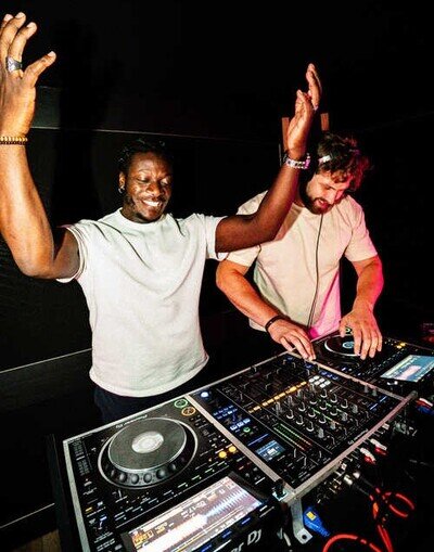 Two DJ's having fun and mixing together