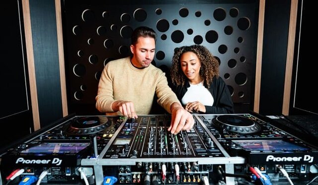 Two DJs rehearsing together in a DJ studio
