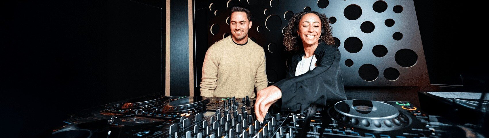 Two DJs rehearsing together in a DJ studio