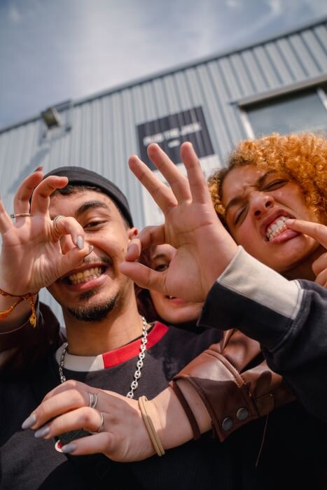 artists smiling and making faces in front of the Plug The Jack building | © Plug The Jack